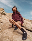 WILD Inked Female Posing On Rocky Terrain with Wide Toe Box Minimalistic Hiking Shoes
