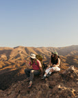 WILD Kai Hanging Out Hikers resting on a rocky mountain ridge wearing LONO WILD barefoot hiking shoes with wide toe box comfort